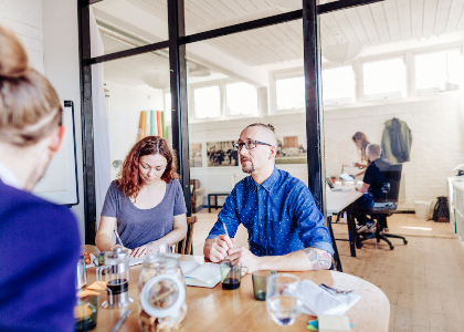 businessman-with-colleagues-working-at-table-in-bo-K2K45YW.jpg