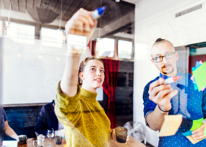 creative-business-people-writing-on-glass-wall-in-3X78A4F.jpg